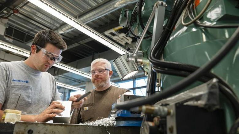 Student and instructor working at MILL machine